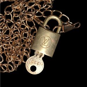 Louis Vuitton vintage lock and key #230 with a non-branded gold-tone chain.